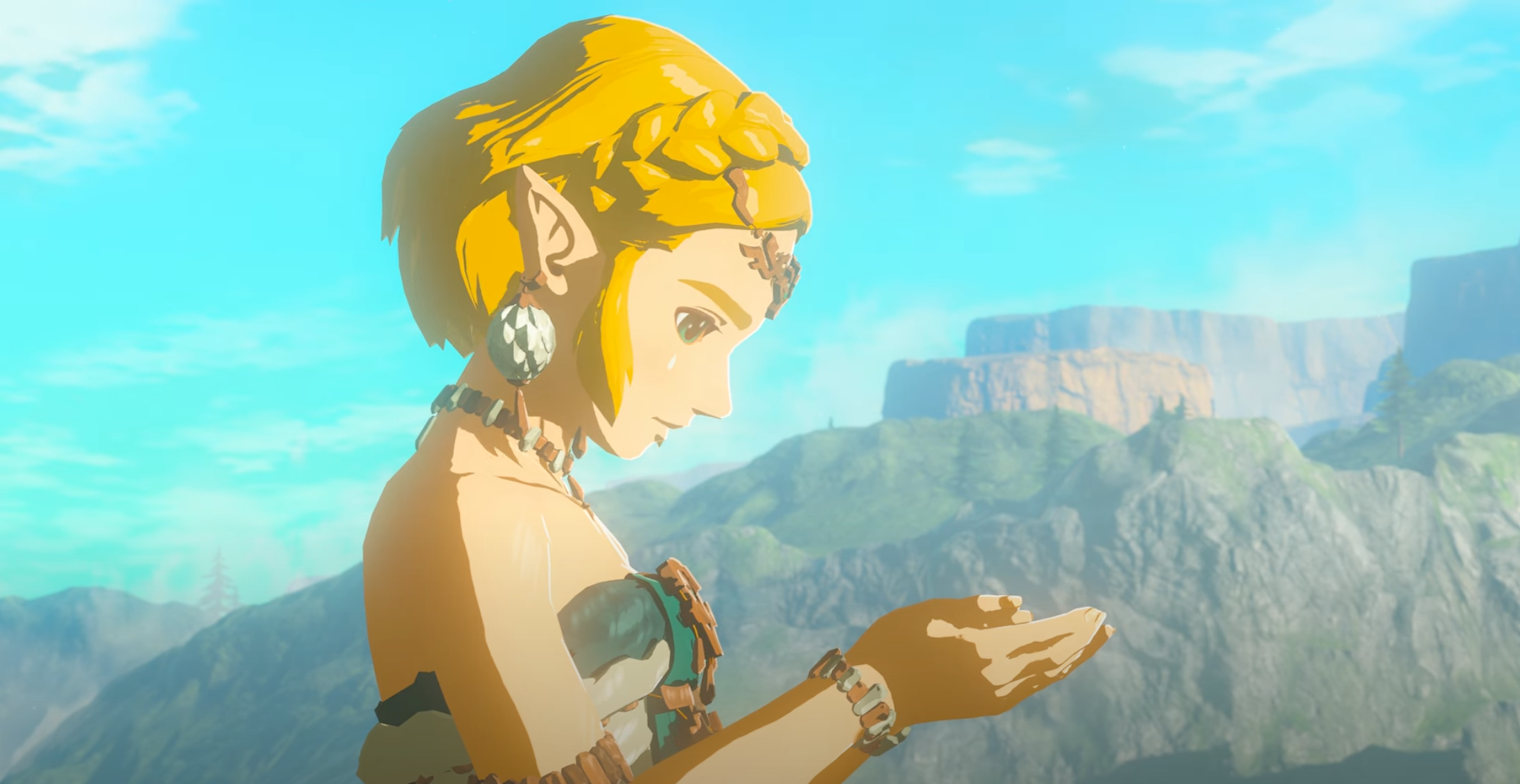 Screenshot taken from the final Legend of Zelda Tears of the Kingdom. It shows Zelda clutching an unseen object.